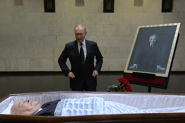 <p>Vladimir Putin pays his last respects at the coffin of Mikhail Gorbachev in Moscow on Thursday </p>