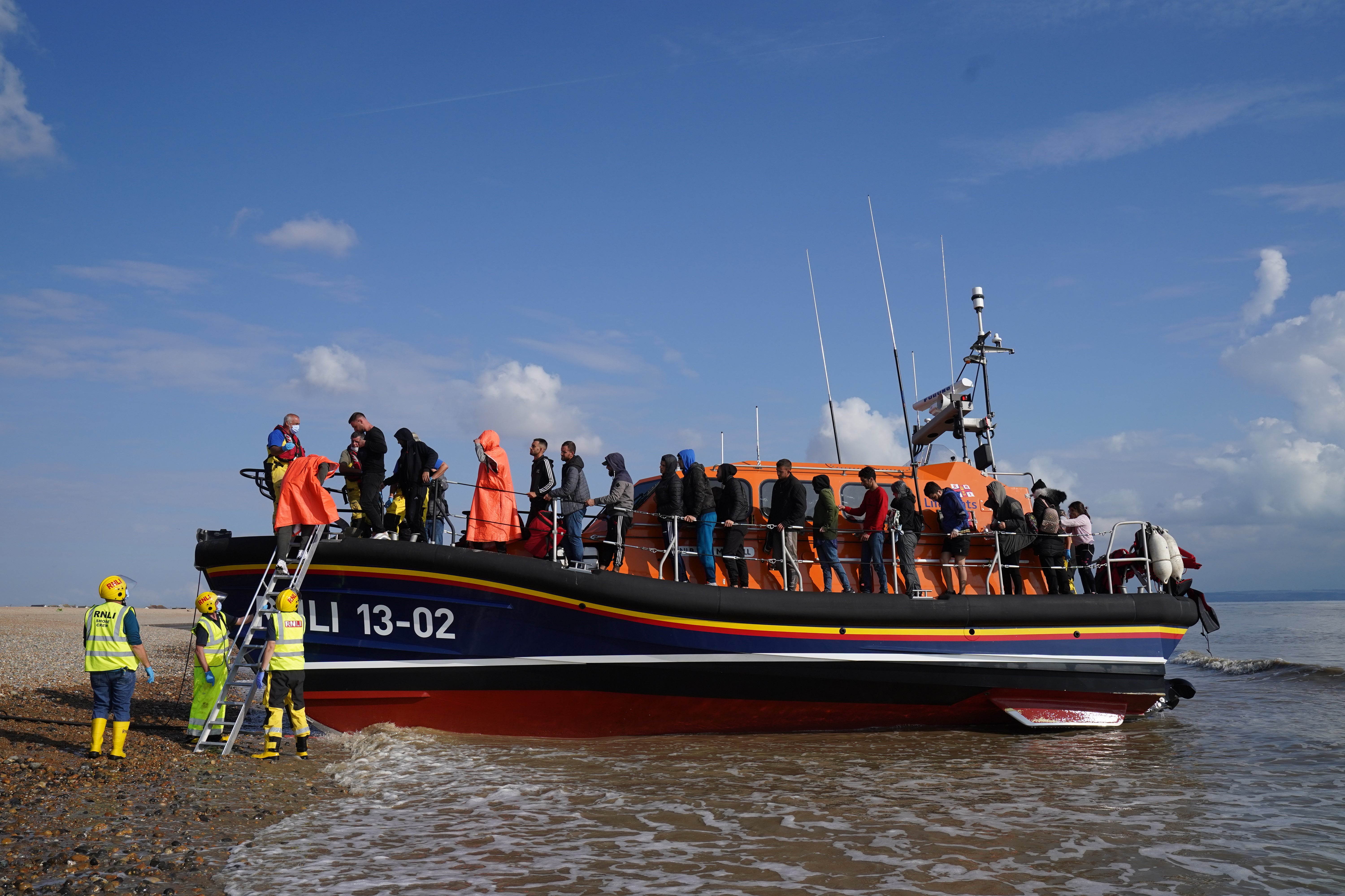 A group of people thought to be migrants are brought in to Dungeness, Kent, onboard an RNLI Lifeboat following a small boat incident in the Channel. Picture date: Saturday August 27, 2022. (Gareth Fuller/PA)