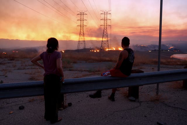 <p>People evacuated from the Route Fire in Los Angeles County in 2023 watch the blaze burn. A massive heatwave in California this week raises concerns of more fires </p>