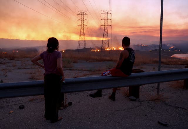 <p>People evacuated from the Route Fire in Los Angeles County in 2023 watch the blaze burn. A massive heatwave in California this week raises concerns of more fires </p>