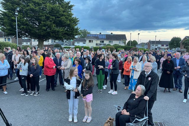 People at St Oliver Plunkett church in Strathfoyle at a vigil for Reuven Simon and Joseph Sebastian (Jonathan McCambridge/PA)