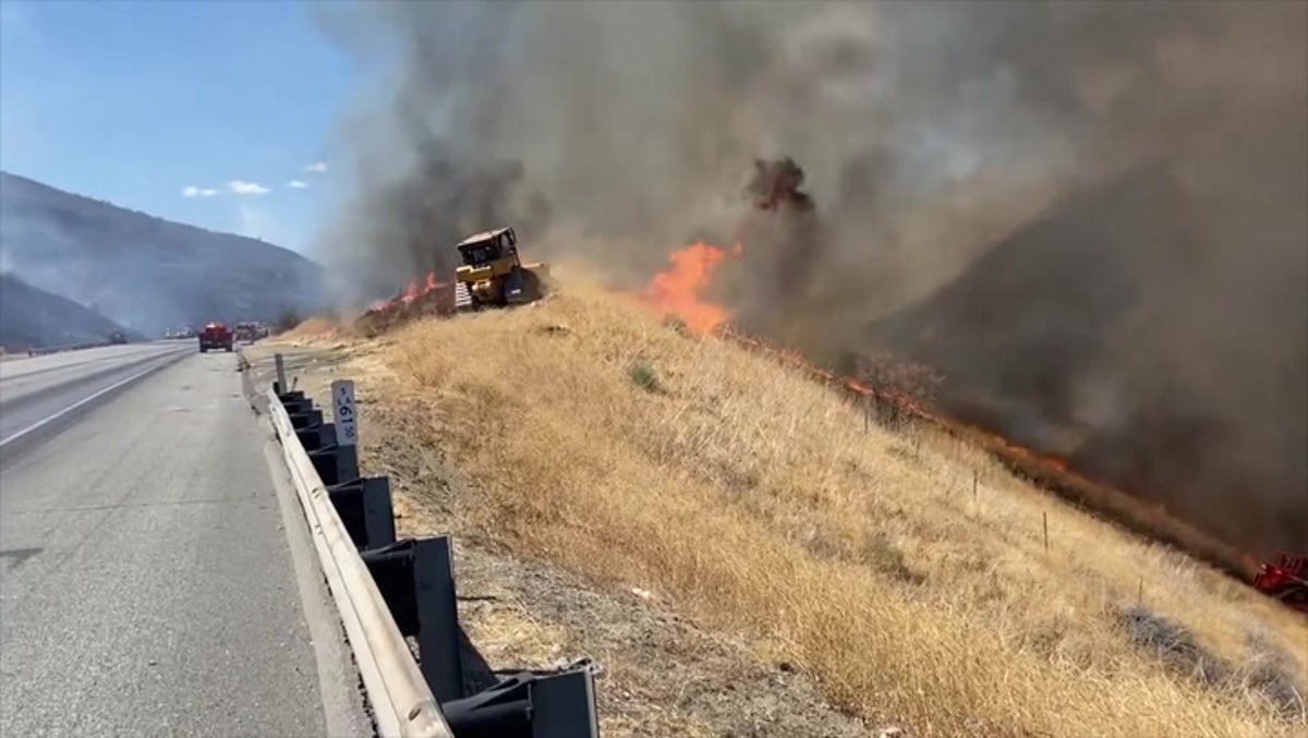 Californian fields ravaged by raging wildfire near interstate