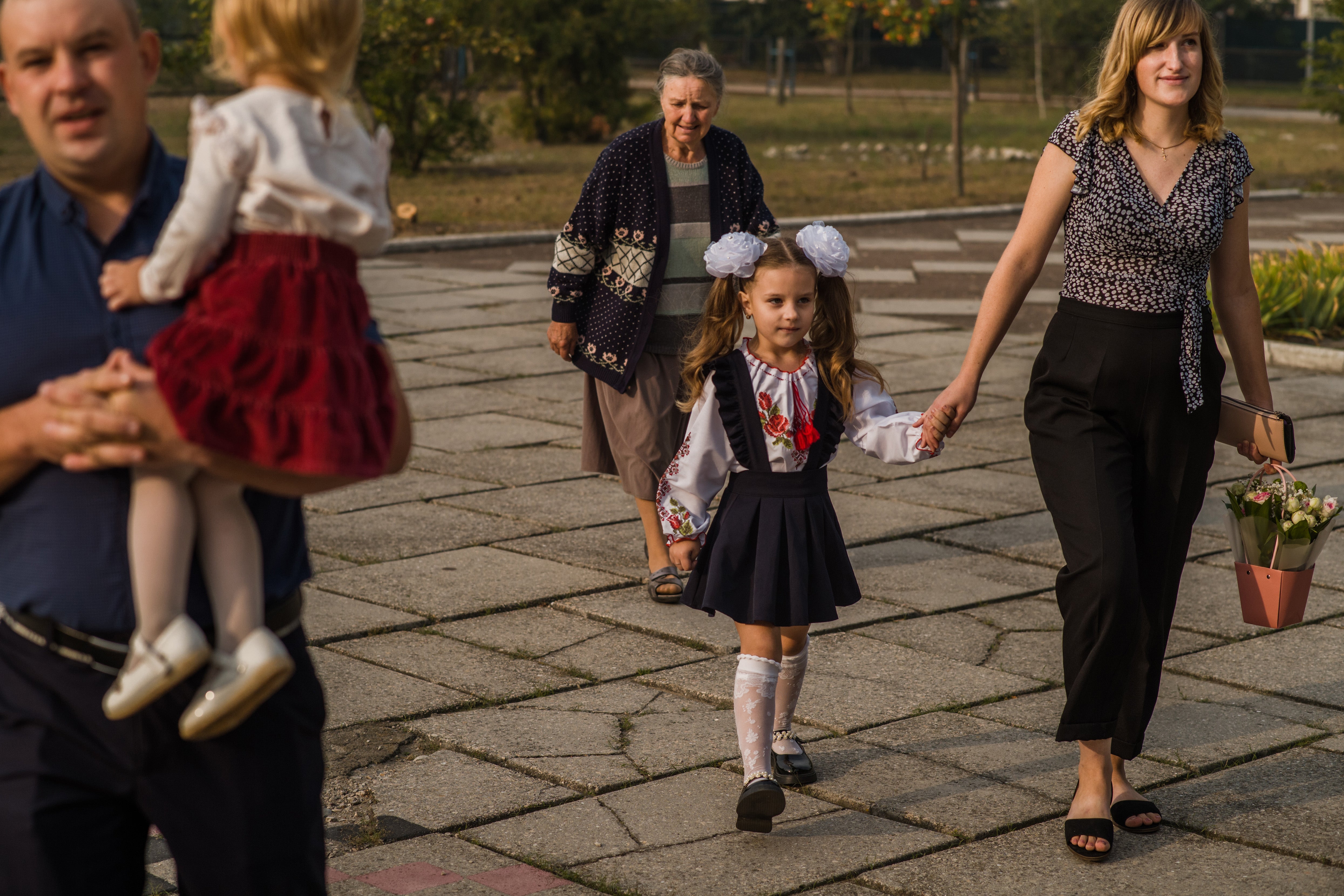 Parents and children walk to school on the first day