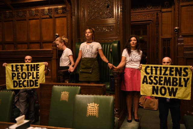 Handout photo taken with permission from the twitter feed of Extinction Rebellion of protesters who have superglued themselves around the Speaker’s chair in the House of Commons chamber, as they call for a Citizen’s Assembly. Picture date: Friday September 2, 2022 (Extinction Rebellion)