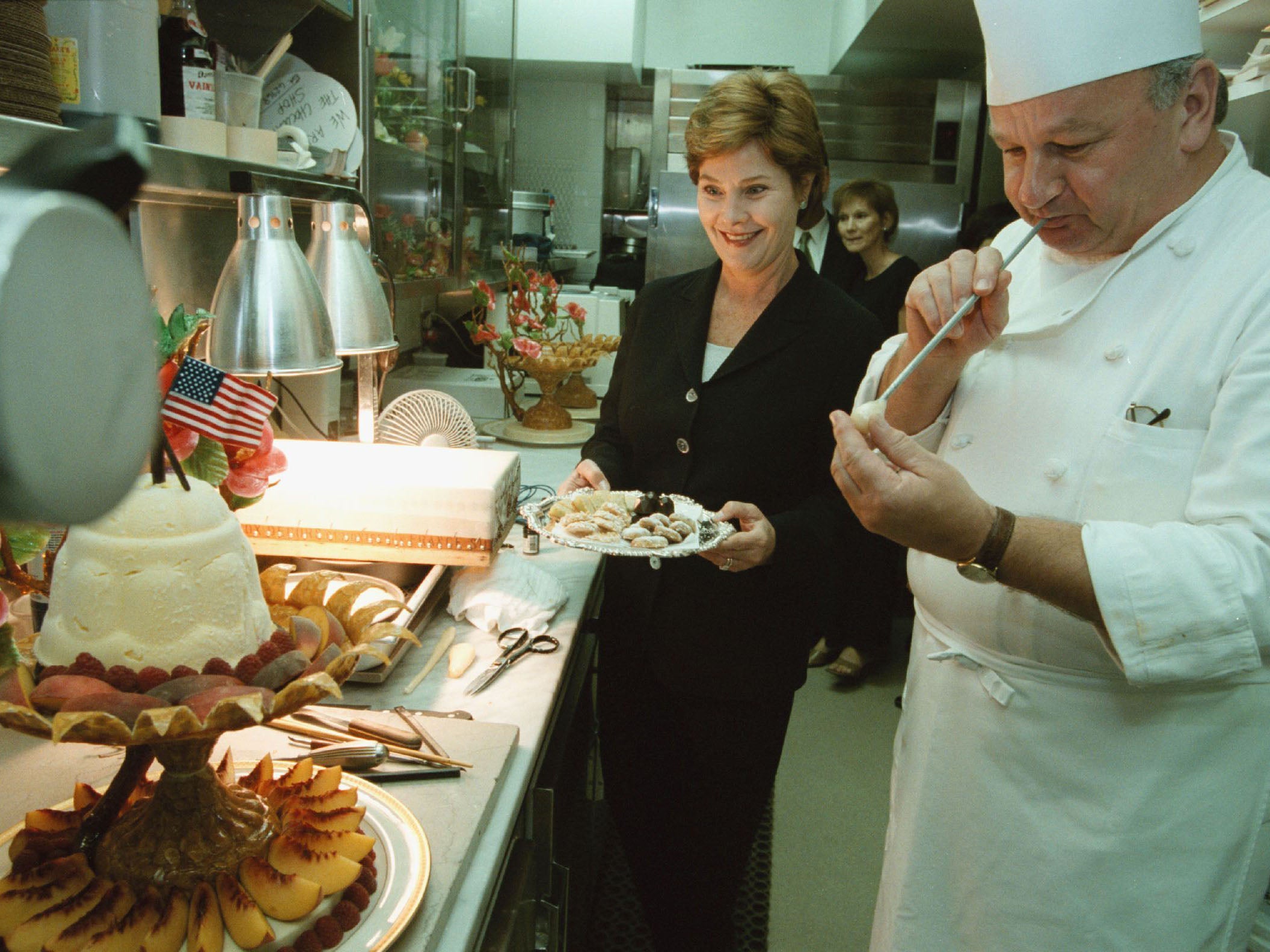 First lady Laura Bush stands by in the pastry kitchen as Mesnier makes an edible humming bird for a state dinner in 2001