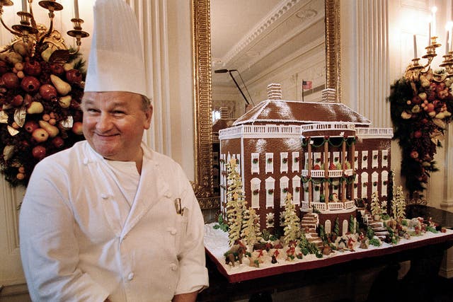 <p>Roland Mesnier shows off the White House gingerbread house in 2002 </p>