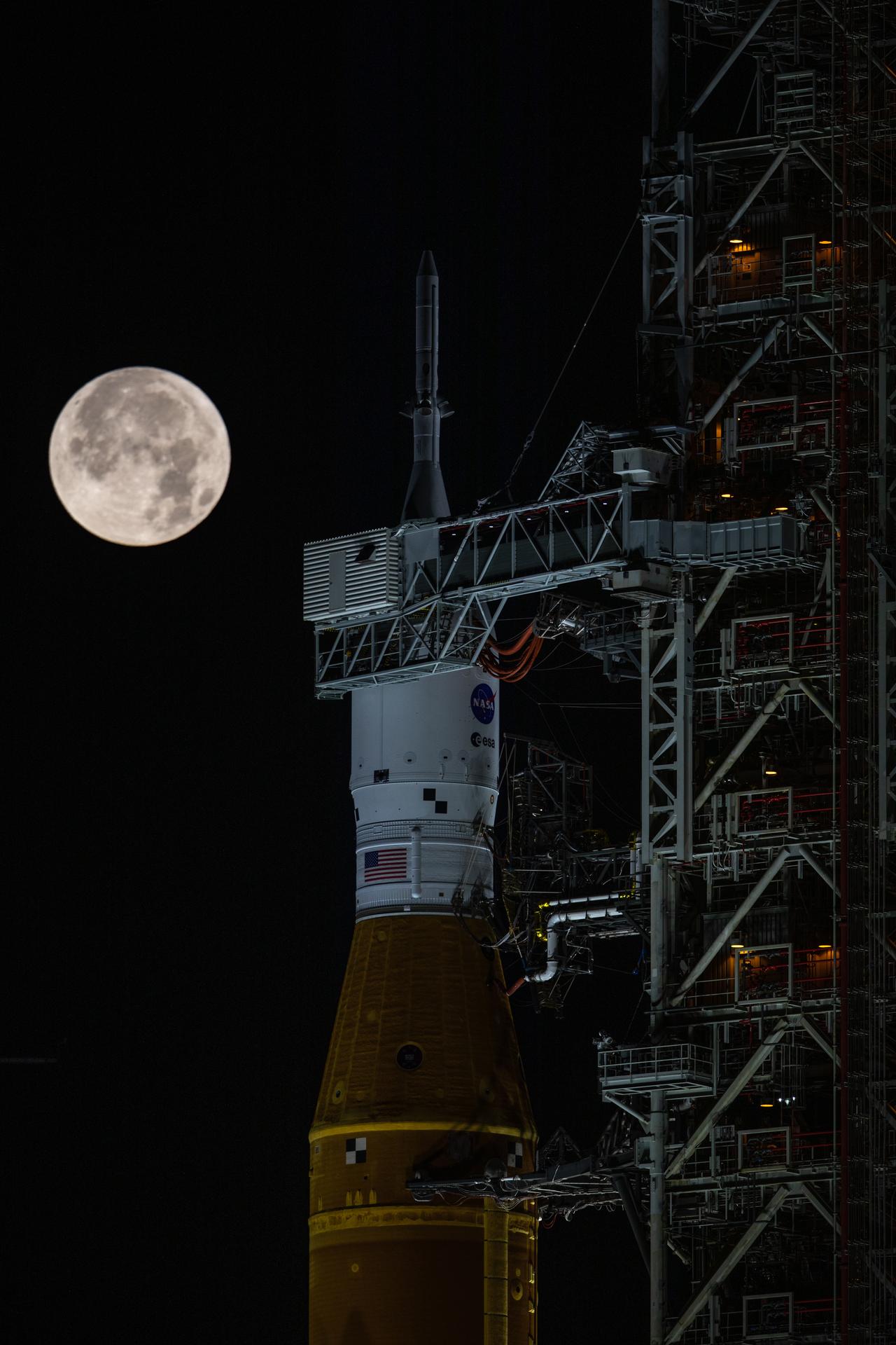 Nasa’s Artemis I mission — the Space Launch System rocket and Orion spacecraft — on the launch pad at Kennedy Space Center beneath a full Moon.