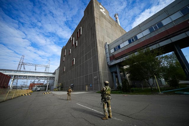 <p>Russian servicemen guard an area of the Zaporizhzhia Nuclear Power Station</p>