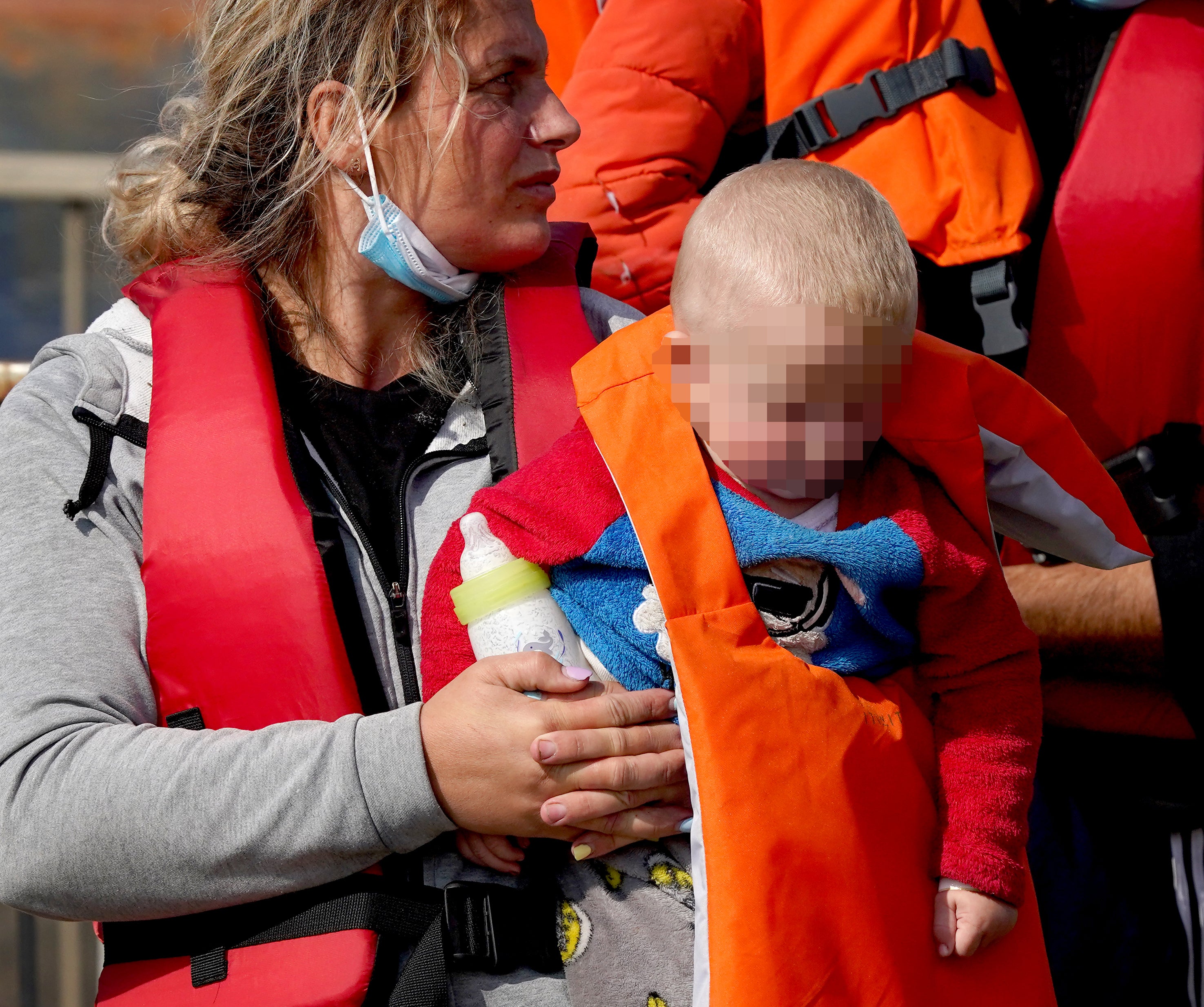 A young child in pyjamas was among the 221 people who made the crossing on Friday (Gareth Fuller/PA)