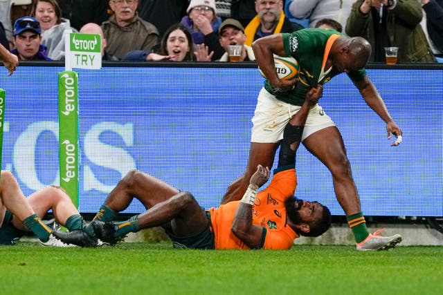 <p>Australia's Marika Koroibete grabs the jersey of South Africa's Makazole Mapimpi, top, after he scores a try</p>