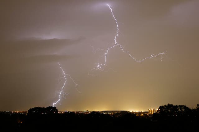 An orange weather warning has been put in place for 13 counties amid the threat of lightning strikes (PA)