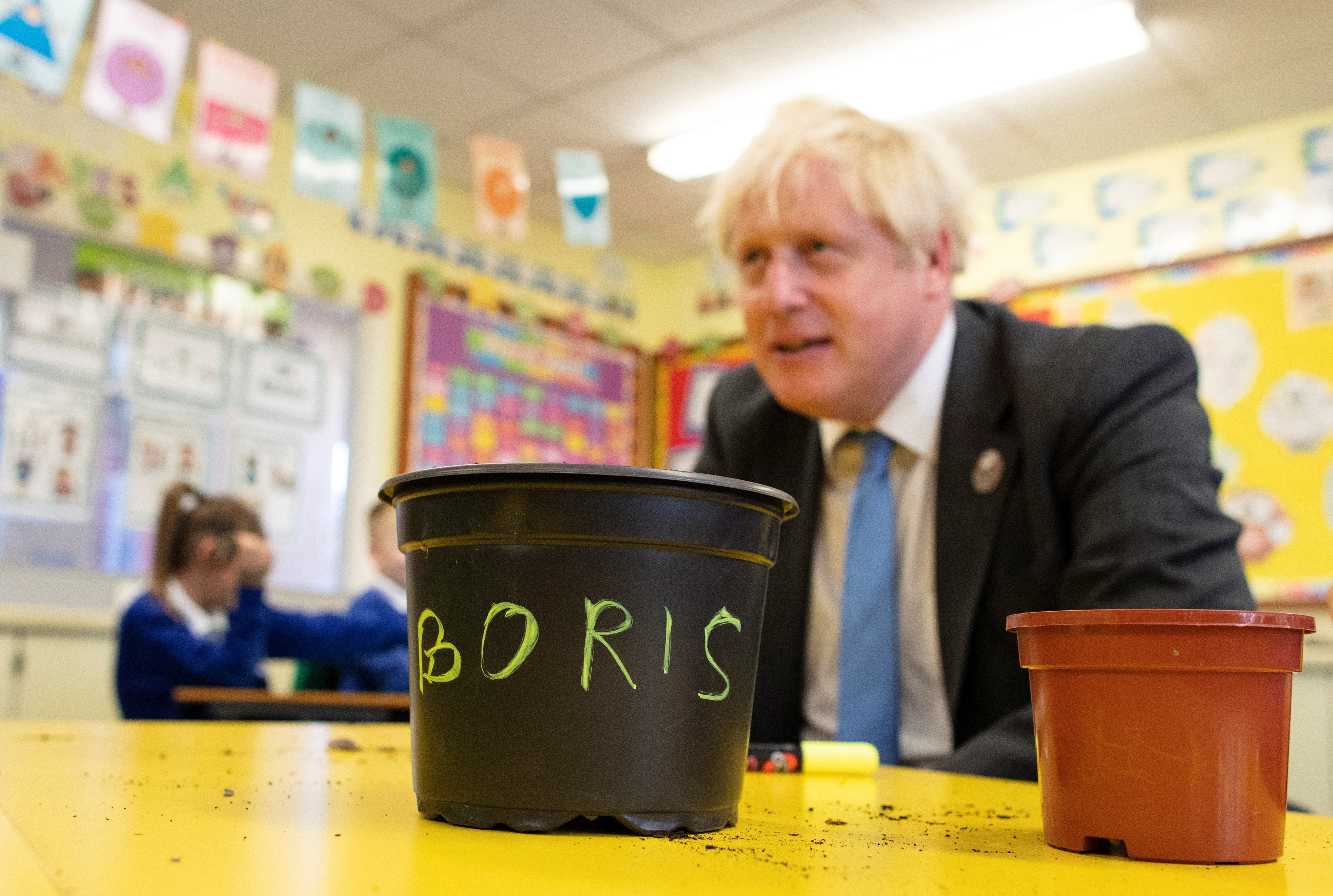 Boris Johnson with schoolchildren at the Crumlin integrated primary school in County Antrim, Northern Ireland in October 2021 (Paul Faith/PA)