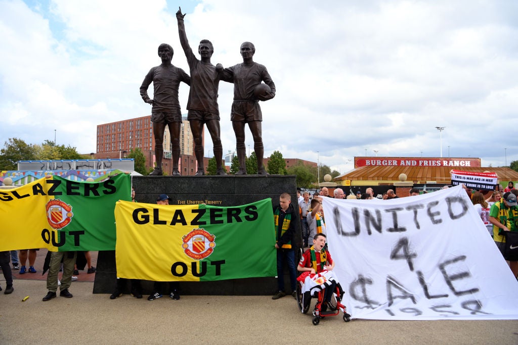 Banners can be seen calling for the Glazer ownership to sell the club