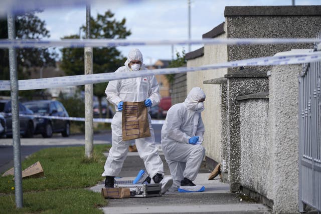Forensic officers remove items from the scene in the Rossfield Estate in Tallaght, Dublin, after the deaths of 18-year-old woman and her brother and sister, twins aged eight, following a violent incident at a house. The Garda Armed Support Unit used less-than-lethal devices to arrest a man in his early 20s at the scene. Picture date: Sunday September 4, 2022.