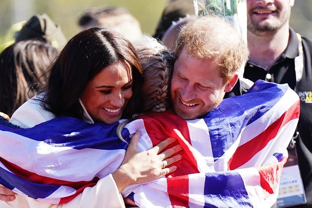 The Duke and Duchess of Sussex hug Team United Kingdom competitor Lisa Johnston at the Invictus Games athletics events in the Athletics Park, at Zuiderpark the Hague, Netherlands. Picture date: Sunday April 17, 2022 (Aaron Chown/PA)