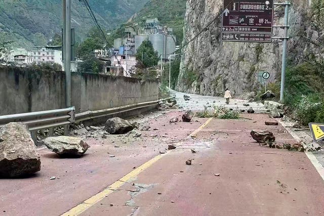 <p>Fallen rocks are seen on a road near Lengqi Town in Luding County, Sichuan after a strong earthquake on 5 September</p>