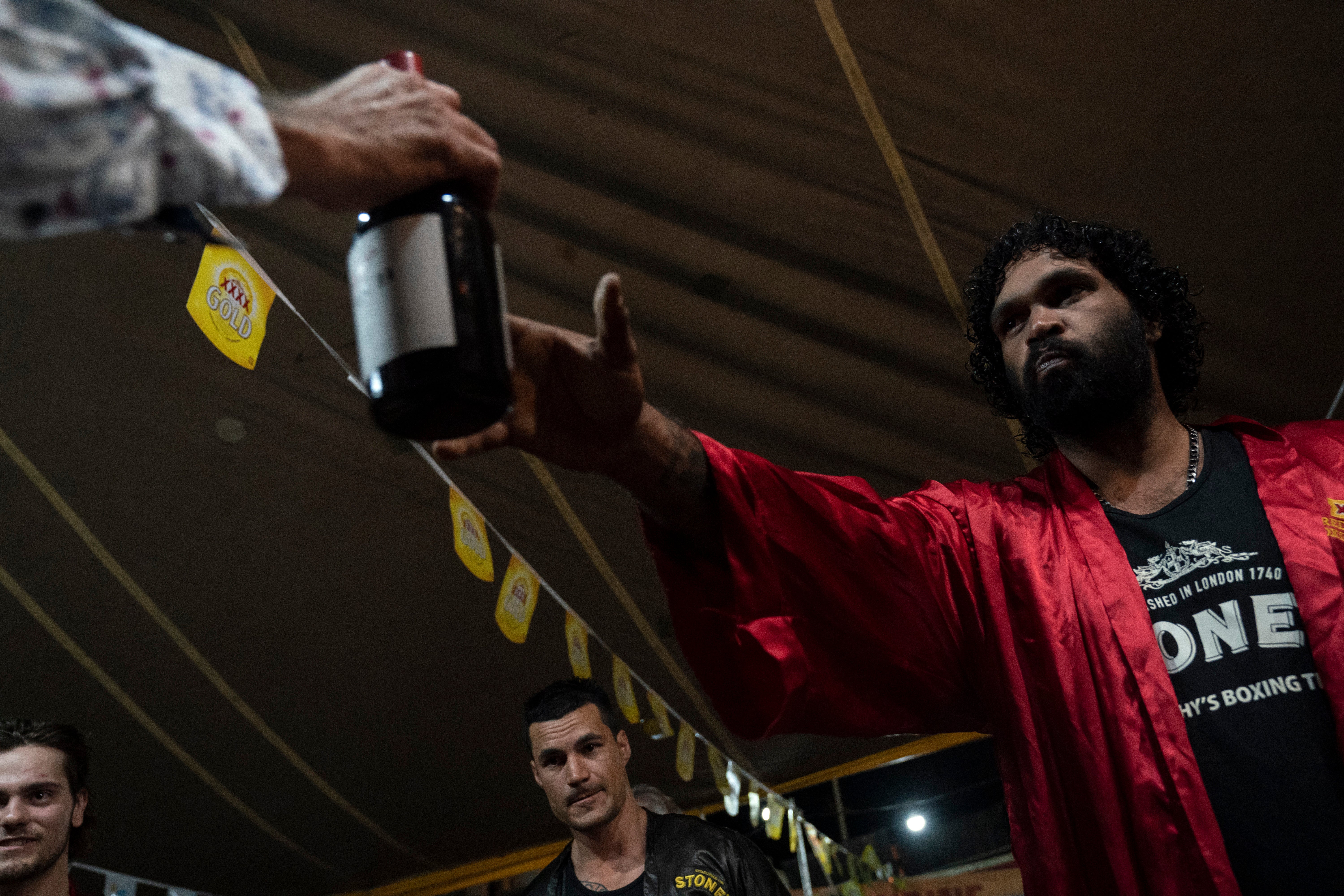 Boxers, including Charles "The Gentleman" Page (right) share a traditional bottle of port before fight night begins