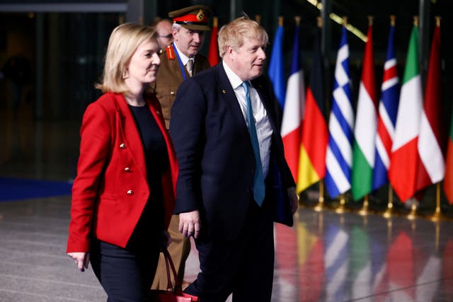 Prime Minister Boris Johnson and Liz Truss leave NATO Headquarters following a summit on Russia’s invasion of Ukraine (Henry Nicholls/PA)