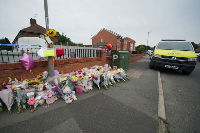 Flowers are left near to the scene of an incident in Kingsheath Avenue, Knotty Ash, Liverpool, where nine-year-old Olivia Pratt-Korbel was fatally shot on Monday night. Picture date: Thursday August 25, 2022.