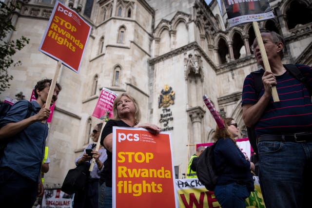 <p>Protesters demonstrate against the government plan to deport asylum seekers to Rwanda at the Royal Courts of Justice in London on Monday </p>
