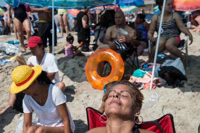 <p>A woman sits at the beach on Labor Day in Coney Island September 7, 2015 in the Brooklyn borough of New York City</p>