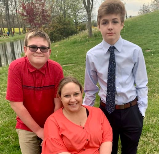Missy Jenkins Smith, pictured with her sons, says she is concerned Carneal will not be able to adjust to life outside of prison and may take stopping his medications