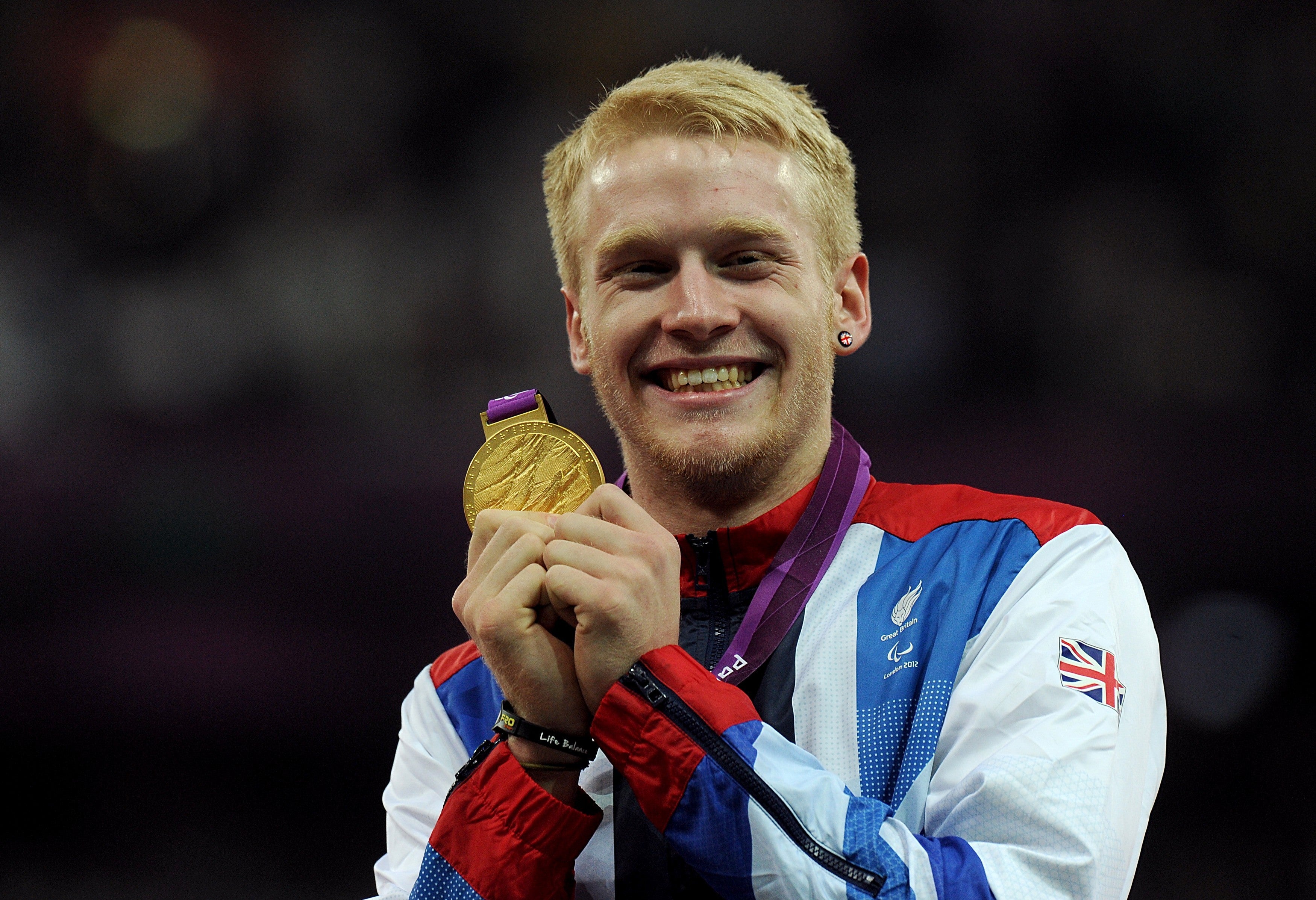 Jonnie Peacock displays the gold medal he won in the men’s 100m – T44 final at London 2012 (Anthony Devlin/PA)