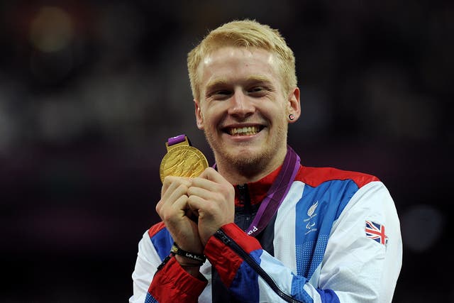 Jonnie Peacock displays the gold medal he won in the men’s 100m – T44 final at London 2012 (Anthony Devlin/PA)