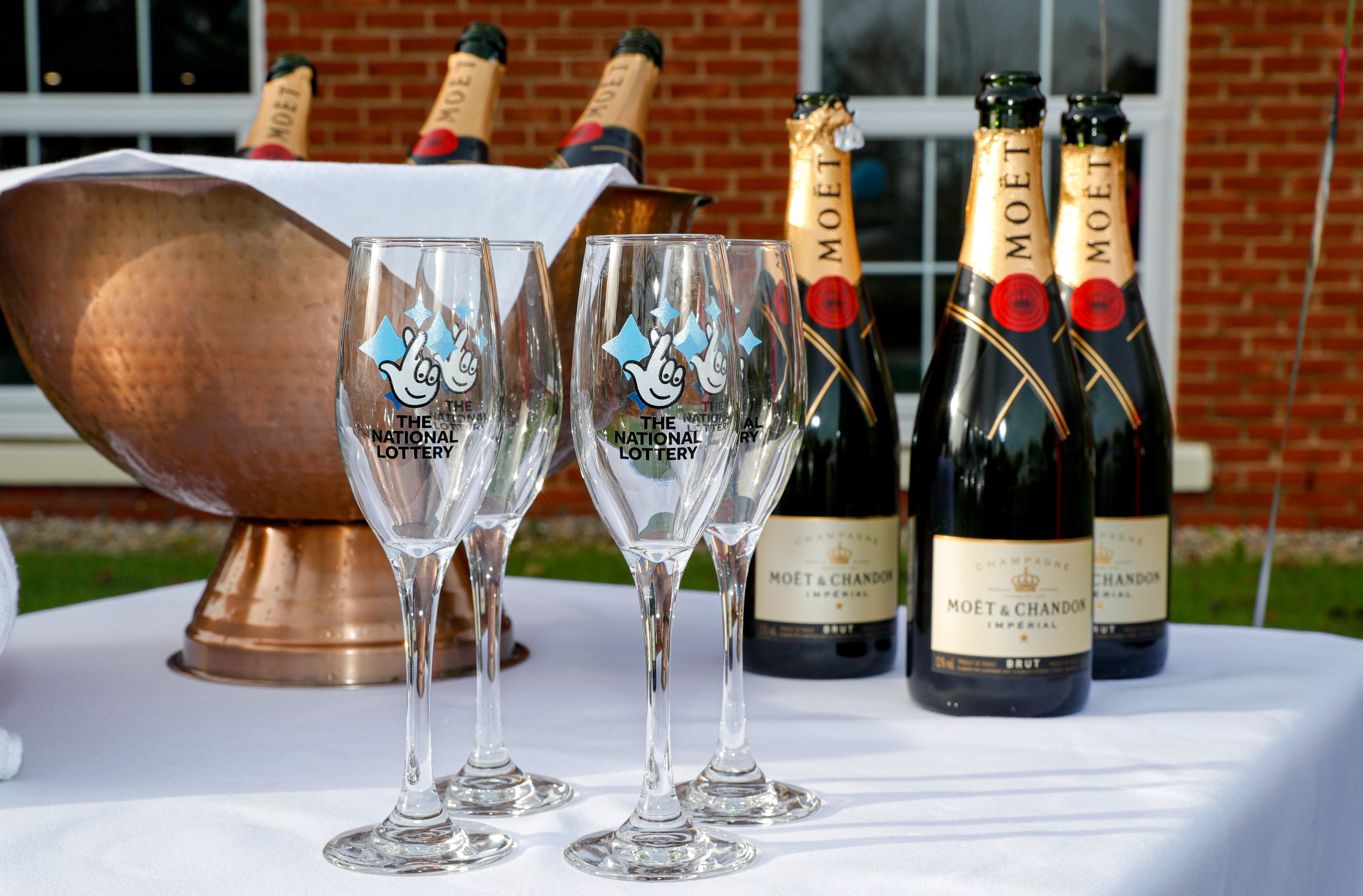 Bottles of Moet & Chandon champagne with The National Lottery branded champagne flutes (Peter Byrne/PA)