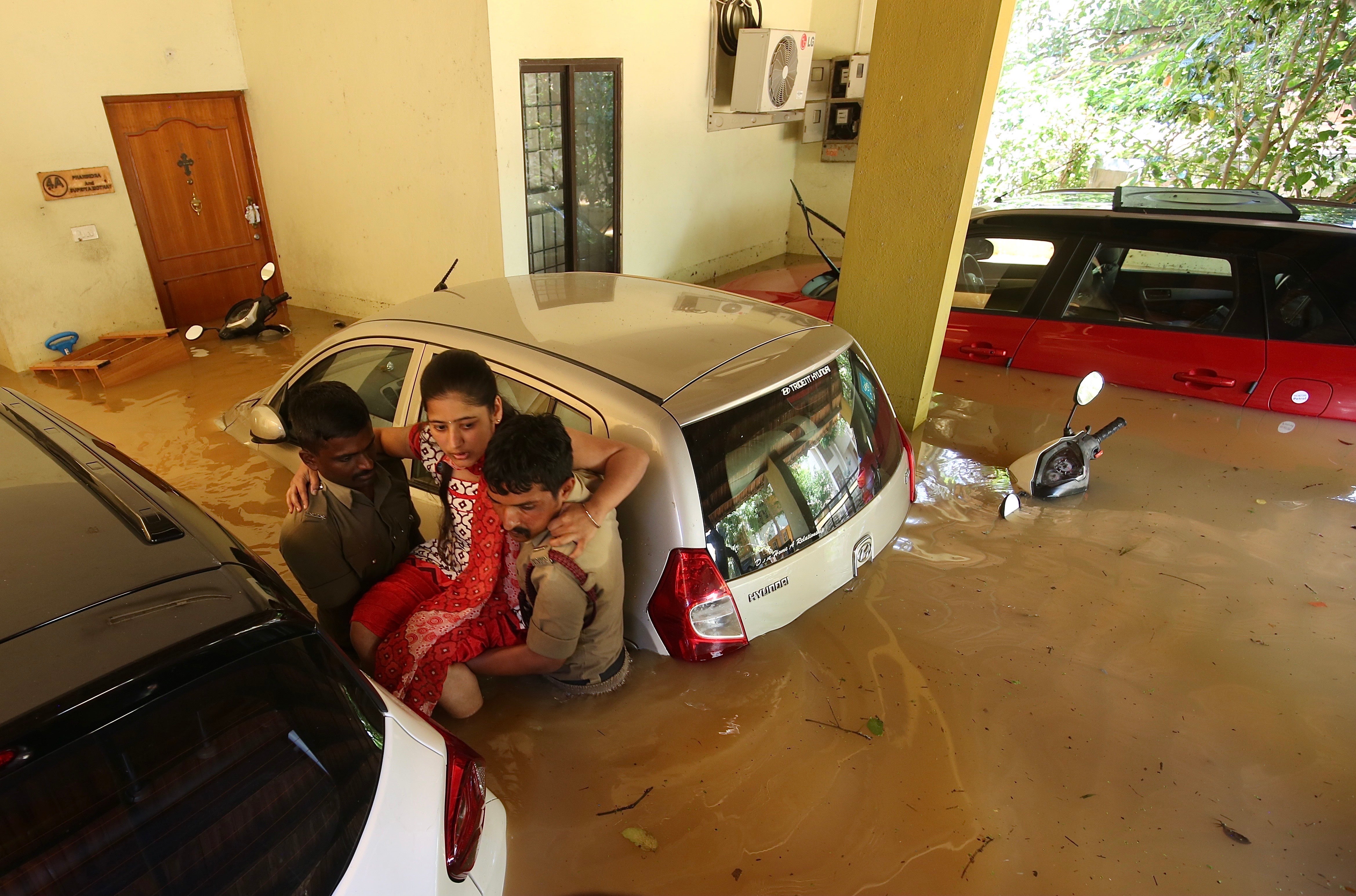 Firefighters rescue the residents of the flooded areas following overnight heavy rainfall in Bangalore, India