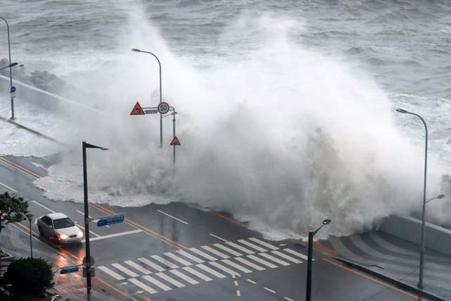 <p>Waves crash along a sea wall in Busan, as Typhoon Hinnamnor hit South Korea’s southern province</p>