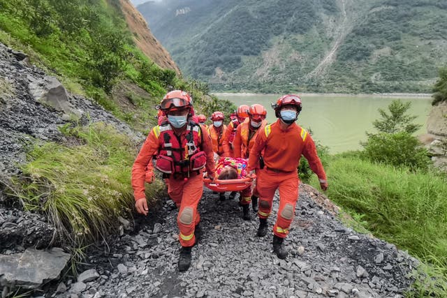 <p>Rescue workers carry an injured person after a 6.6-magnitude earthquake in Luding county, Ganzi Prefecture in China's southwestern Sichuan province</p>