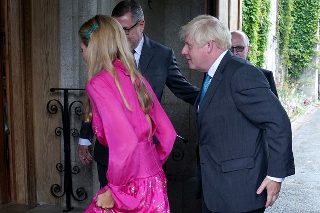 Boris Johnson and his wife Carrie Johnson are greeted at Balmoral (Andrew Milligan/PA)