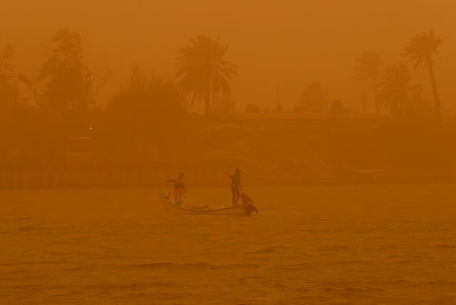<p>Fishermen in a sandstorm in Basra, Iraq</p>