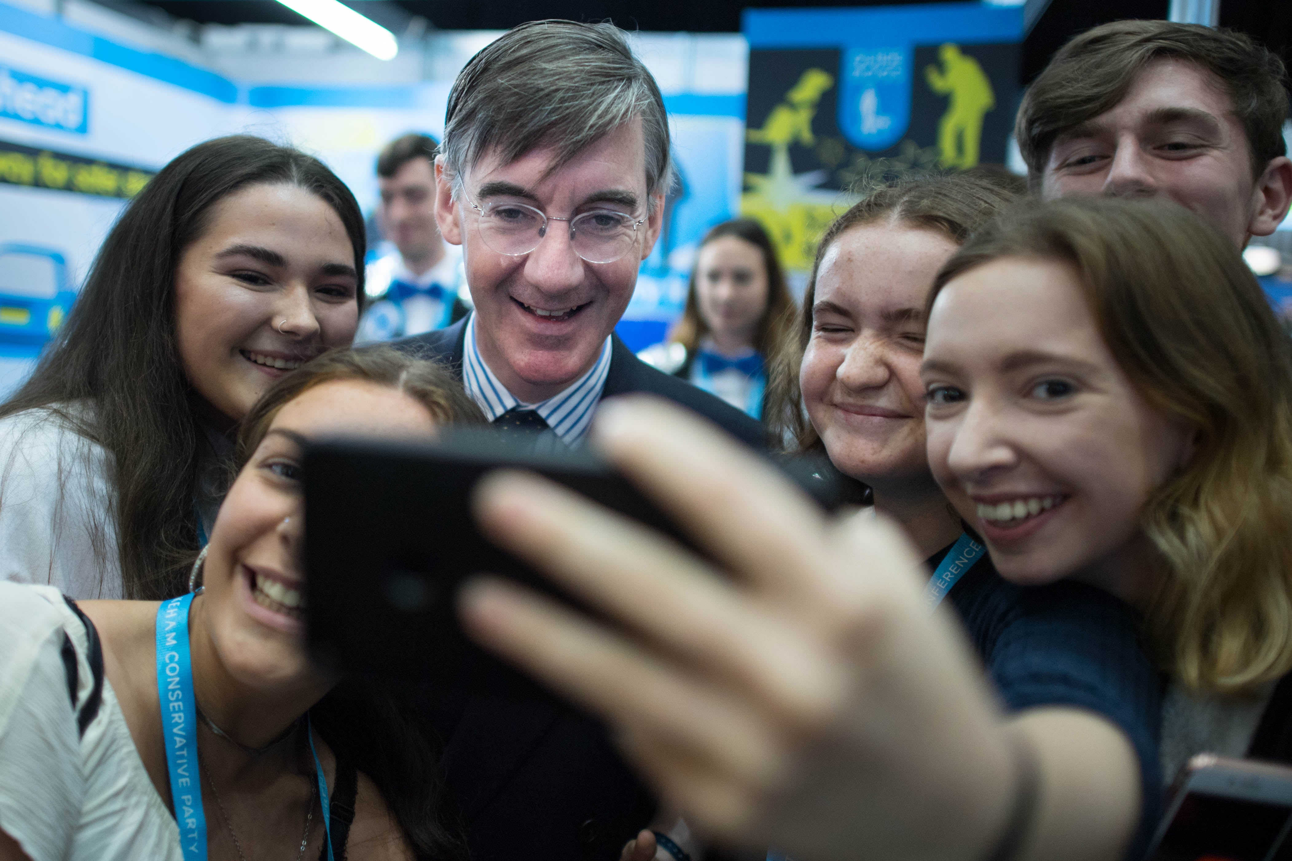 Jacob Rees-Mogg with young people during a Conservative Party Conference (Stefan Rousseau/PA)
