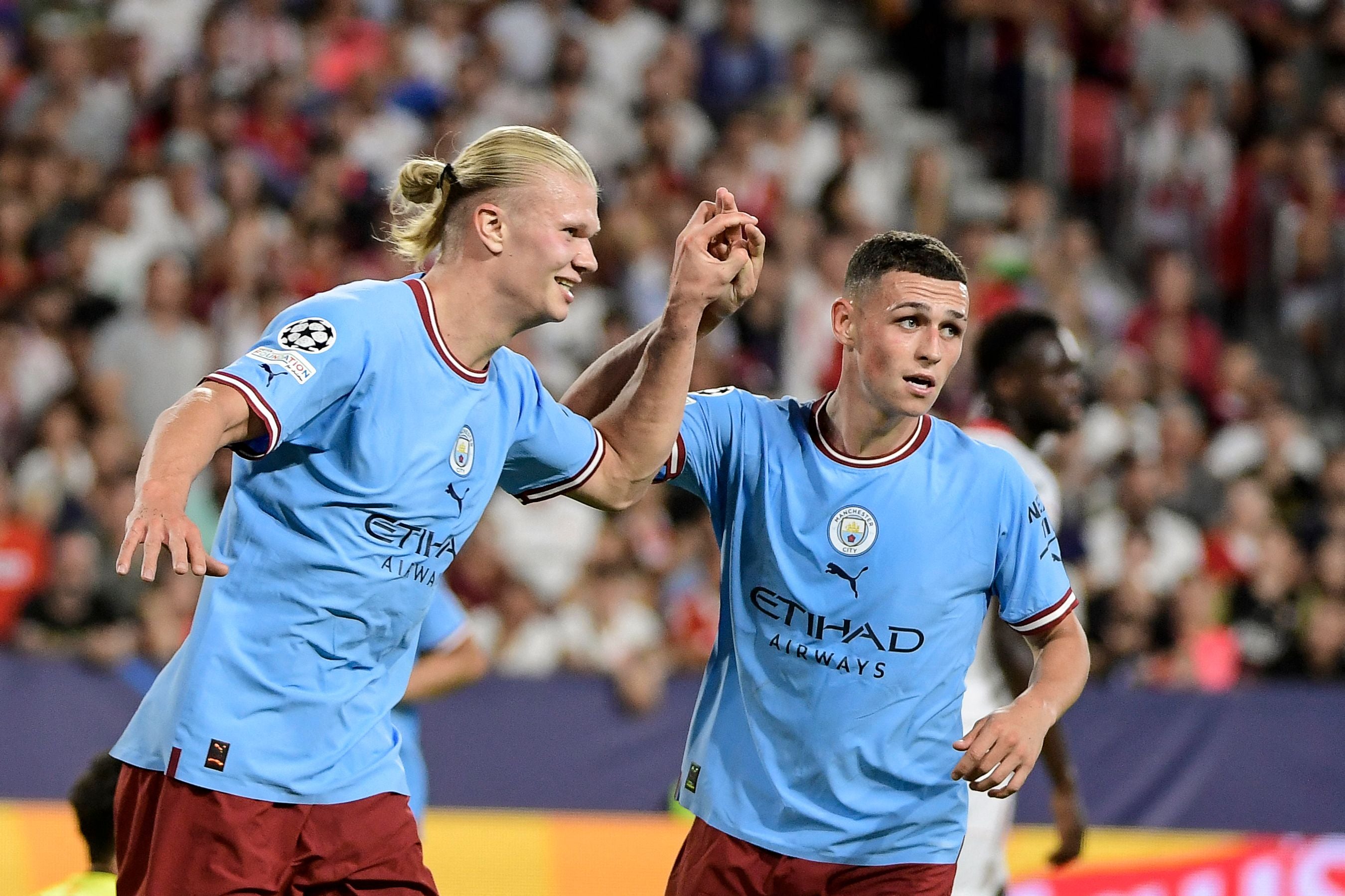 Erling Haaland and Phil Foden celebrate City’s third goal