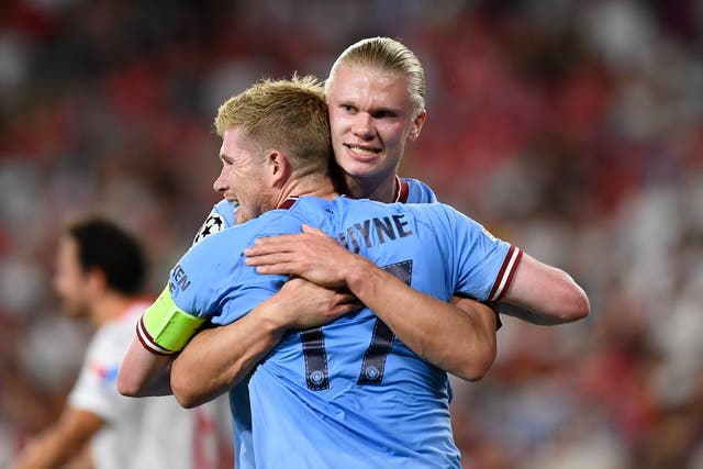 Erling Haaland, right, embraces Kevin De Bruyne after scoring Manchester City’s opening goal against Sevilla (Jose Breton/AP)