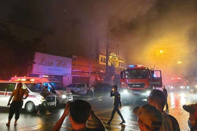 <p>Firefighters at the scene of a deadly fire that engulfed a karaoke bar in Binh Duong province, north of Ho Chi Minh City</p>