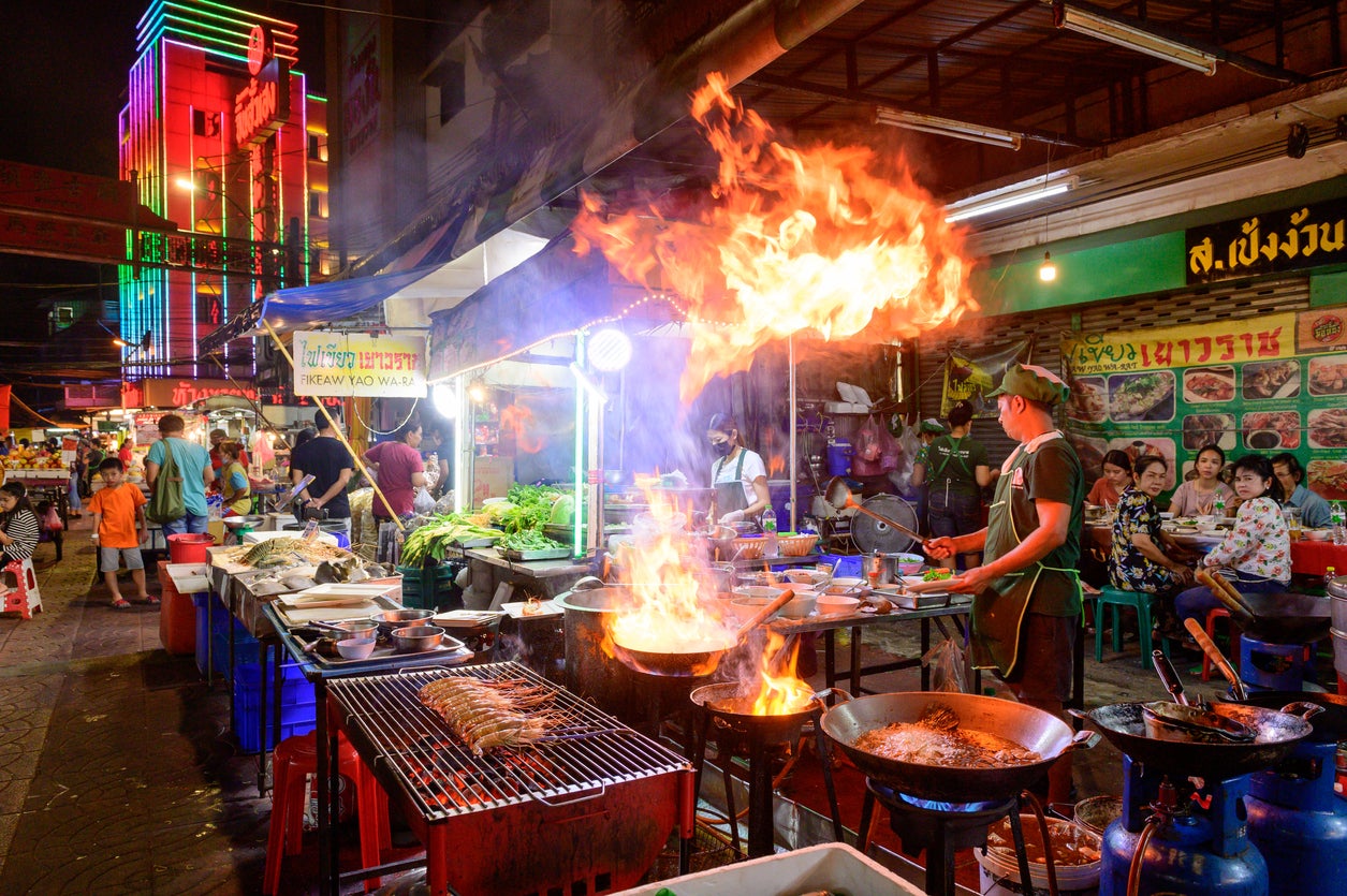 Chef cooking food streetside on Yaowarat road, Bangkok
