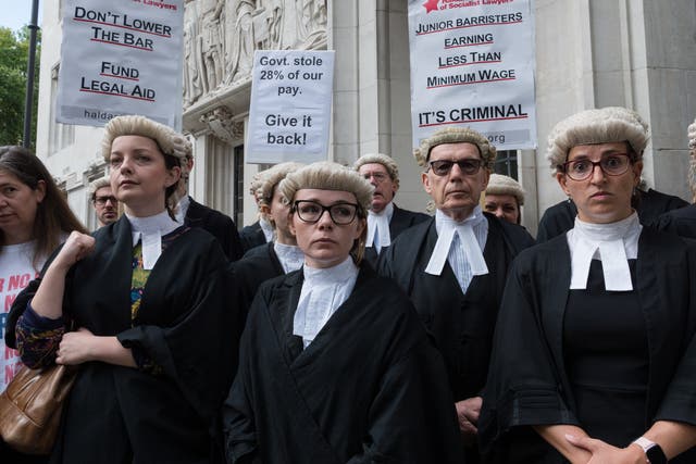 <p>Criminal barristers gather outside the Supreme Court for a rally following the start of an indefinite strike action on 6 September 2022</p>