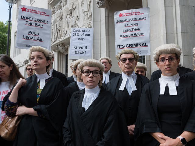 <p>Criminal barristers gather outside the Supreme Court for a rally following the start of an indefinite strike action on 6 September 2022</p>