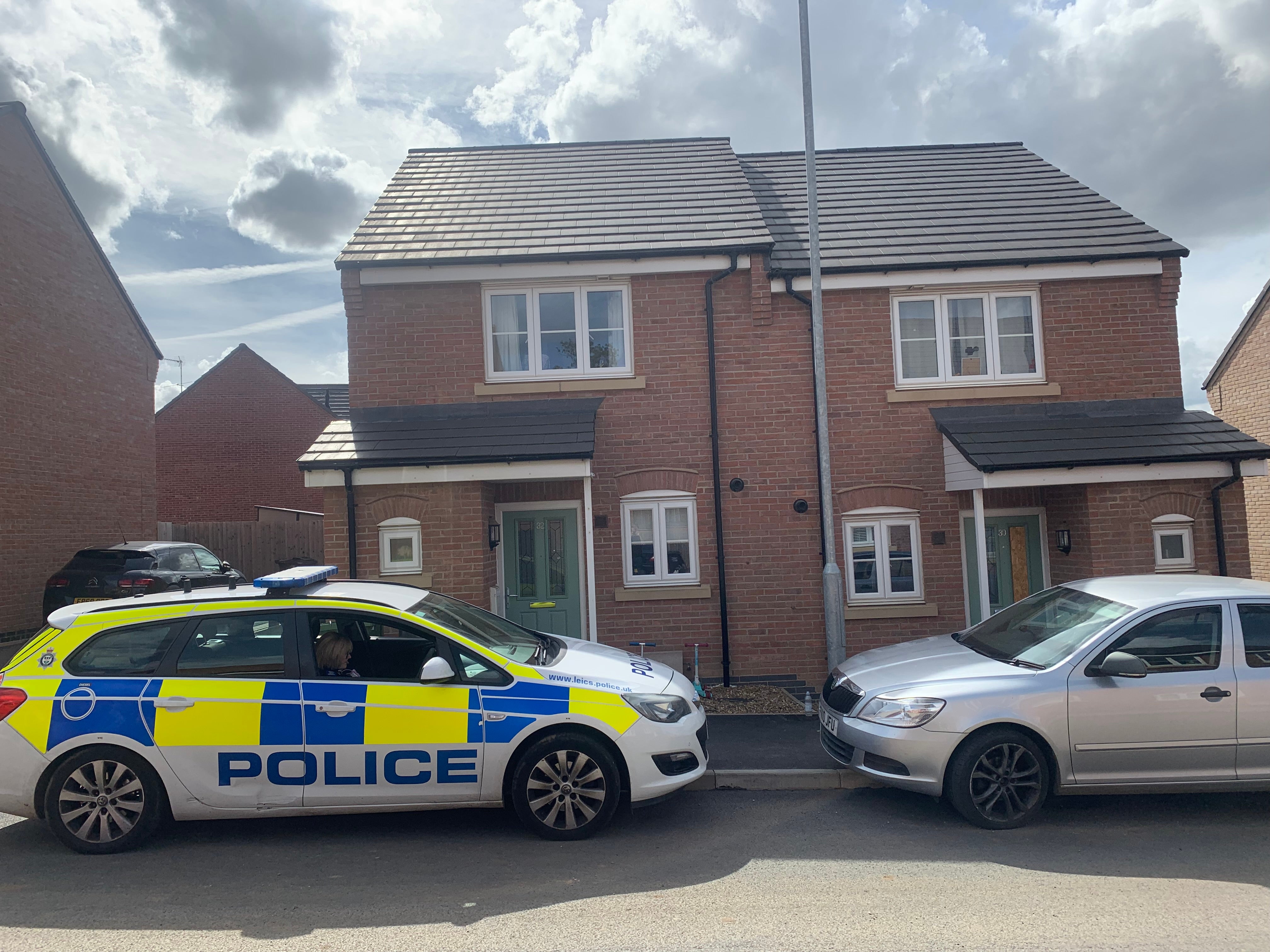 A marked police car outside a property in Field Edge Drive, Barrow upon Soar (Josh Payne/PA)