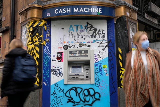 <p>Shoppers pass graffiti on Oxford Street</p>