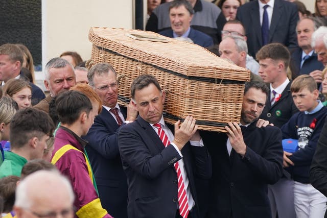 The coffin of Jack de Bromhead is carried out of the church following the funeral (PA)