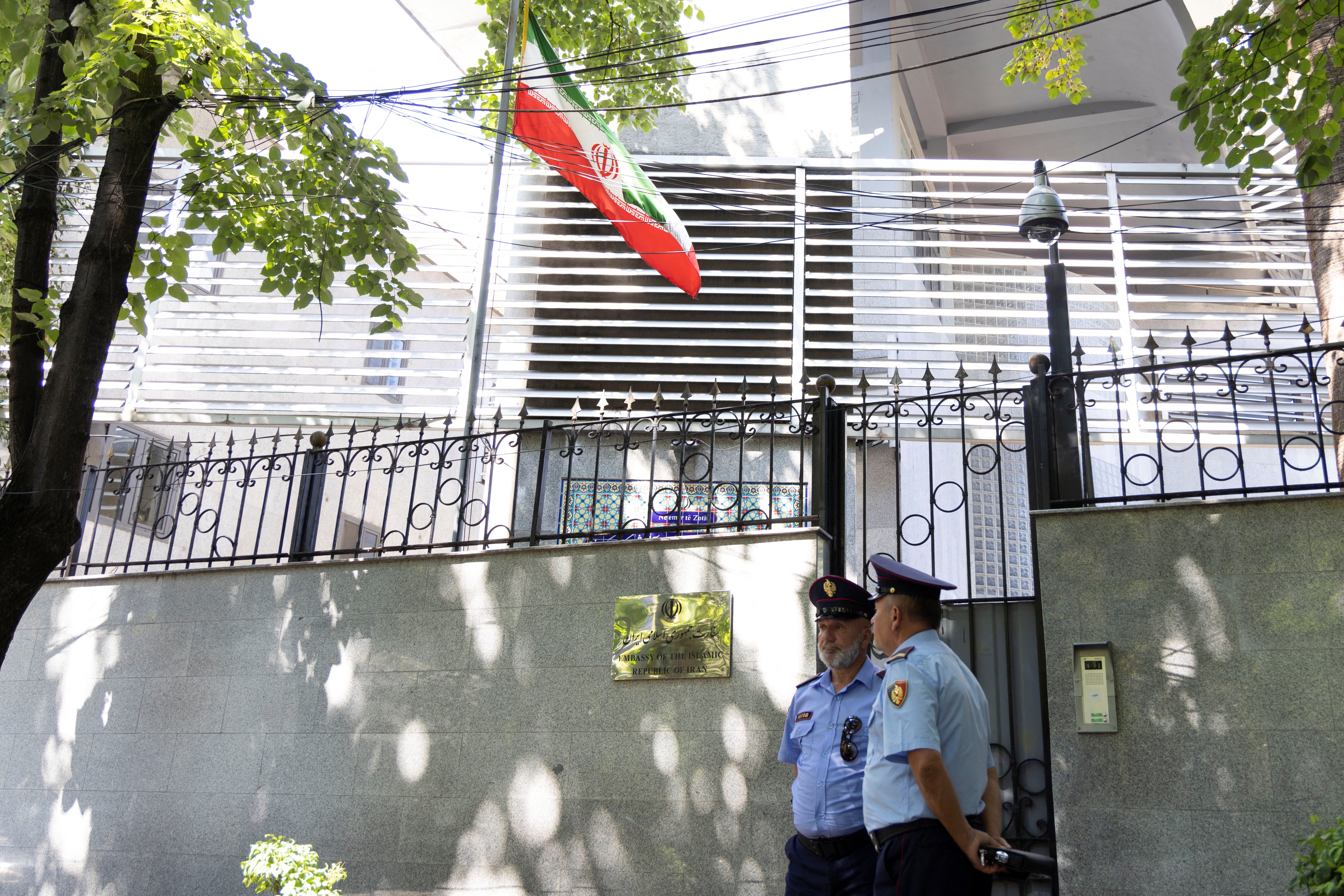 Policemen stand guard outside the Iranian embassy in Tirana