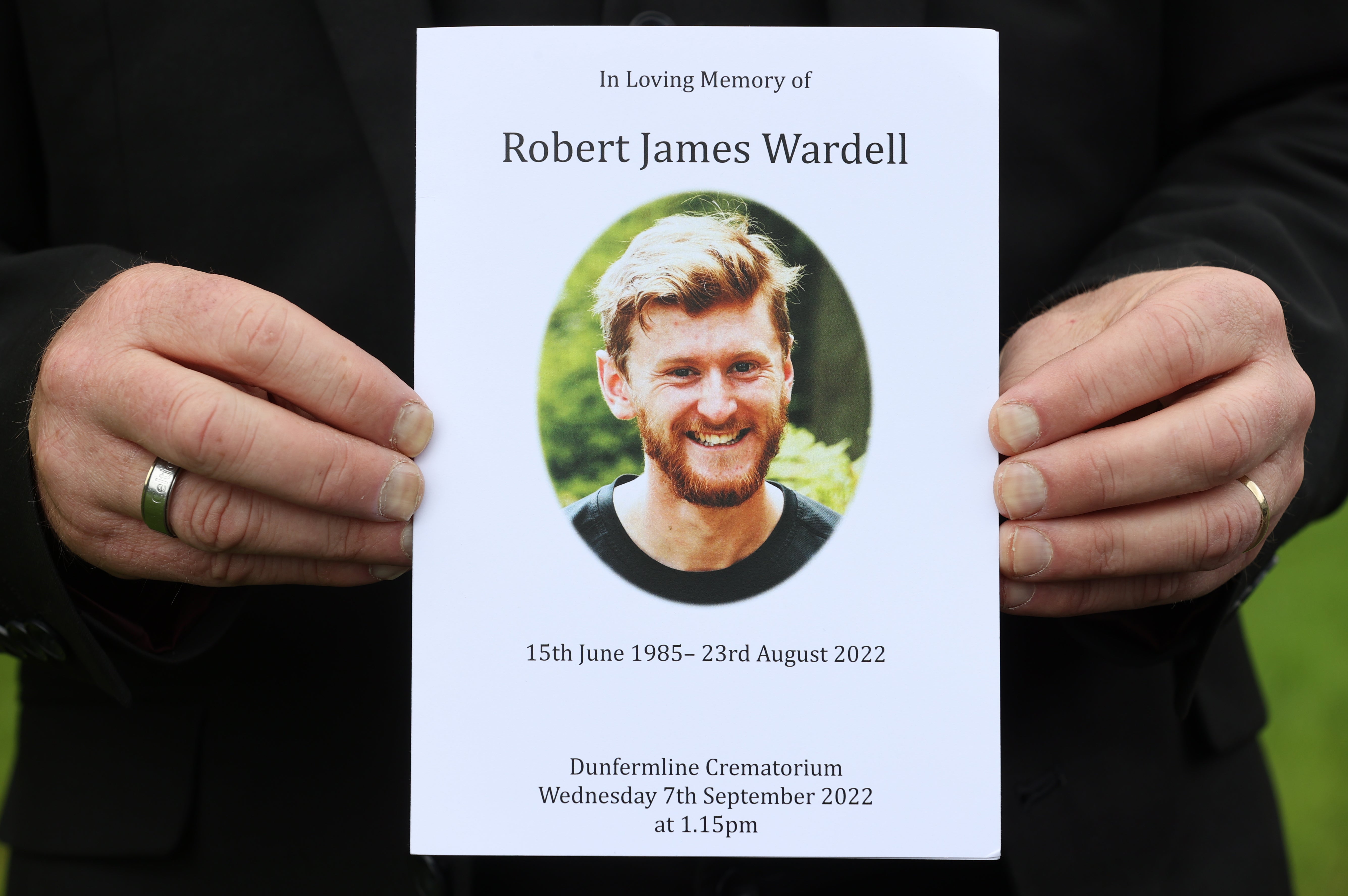 A person holds an order of service outside Dunfermline Crematorium ahead of the funeral of Rab Wardell (Steve Welsh/PA)