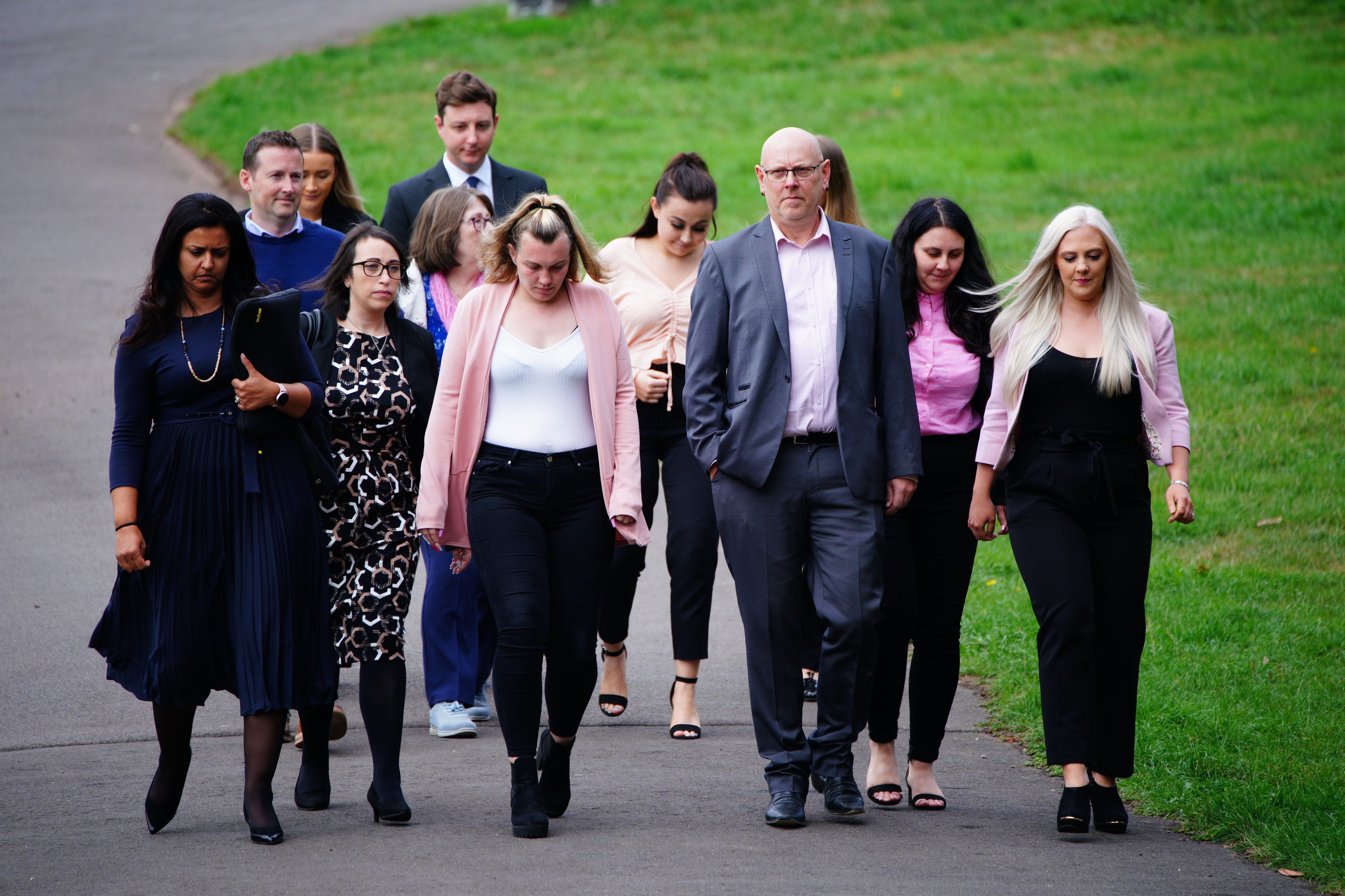 Celia Marsh’s husband Andy (third right), her family and their legal representatives arrive for the inquest on Tuesday