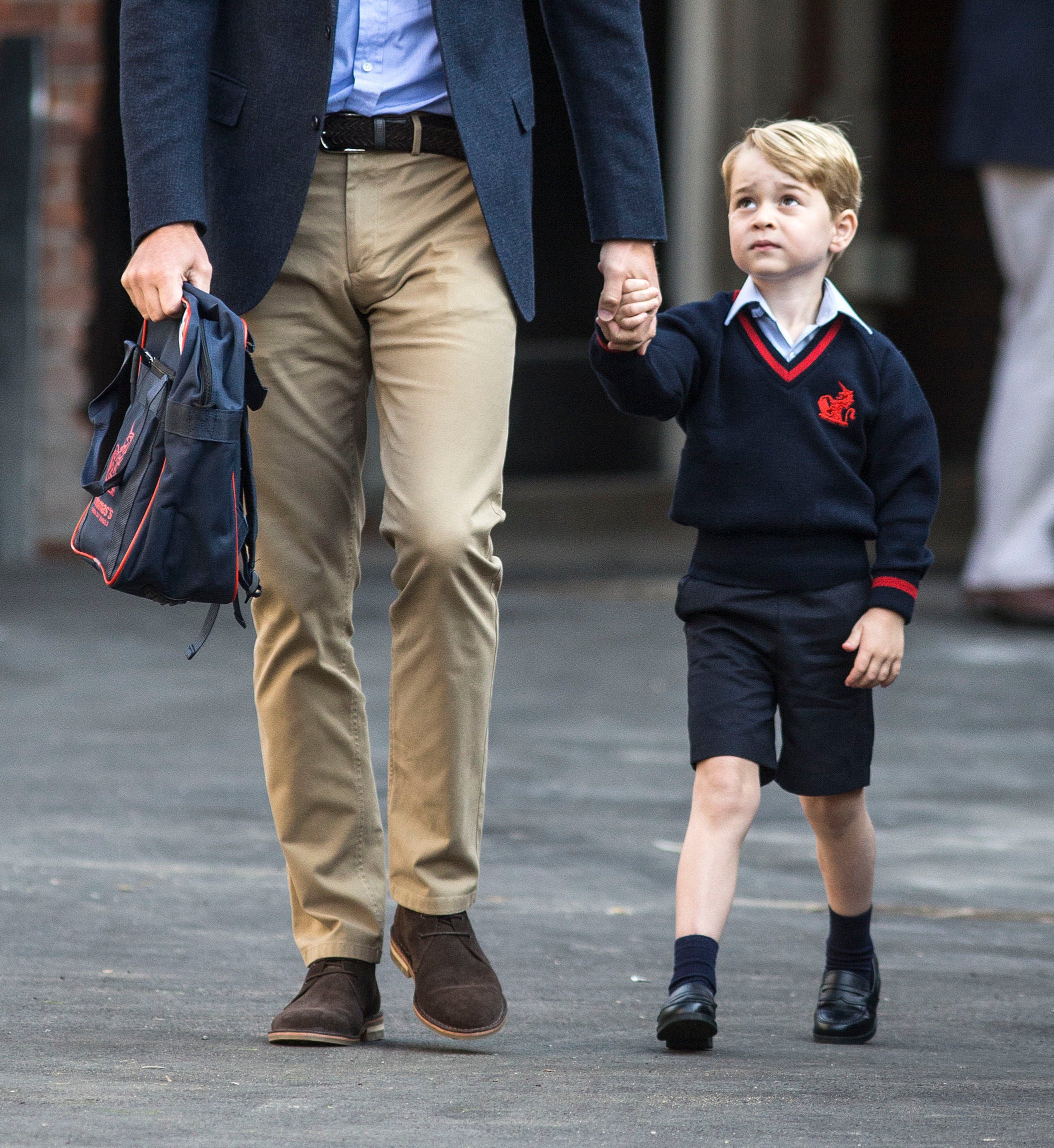 Prince George holds hands with the Duke of Cambridge as he arrives at Thomas’s Battersea (Richard Pohle/The Times/PA)