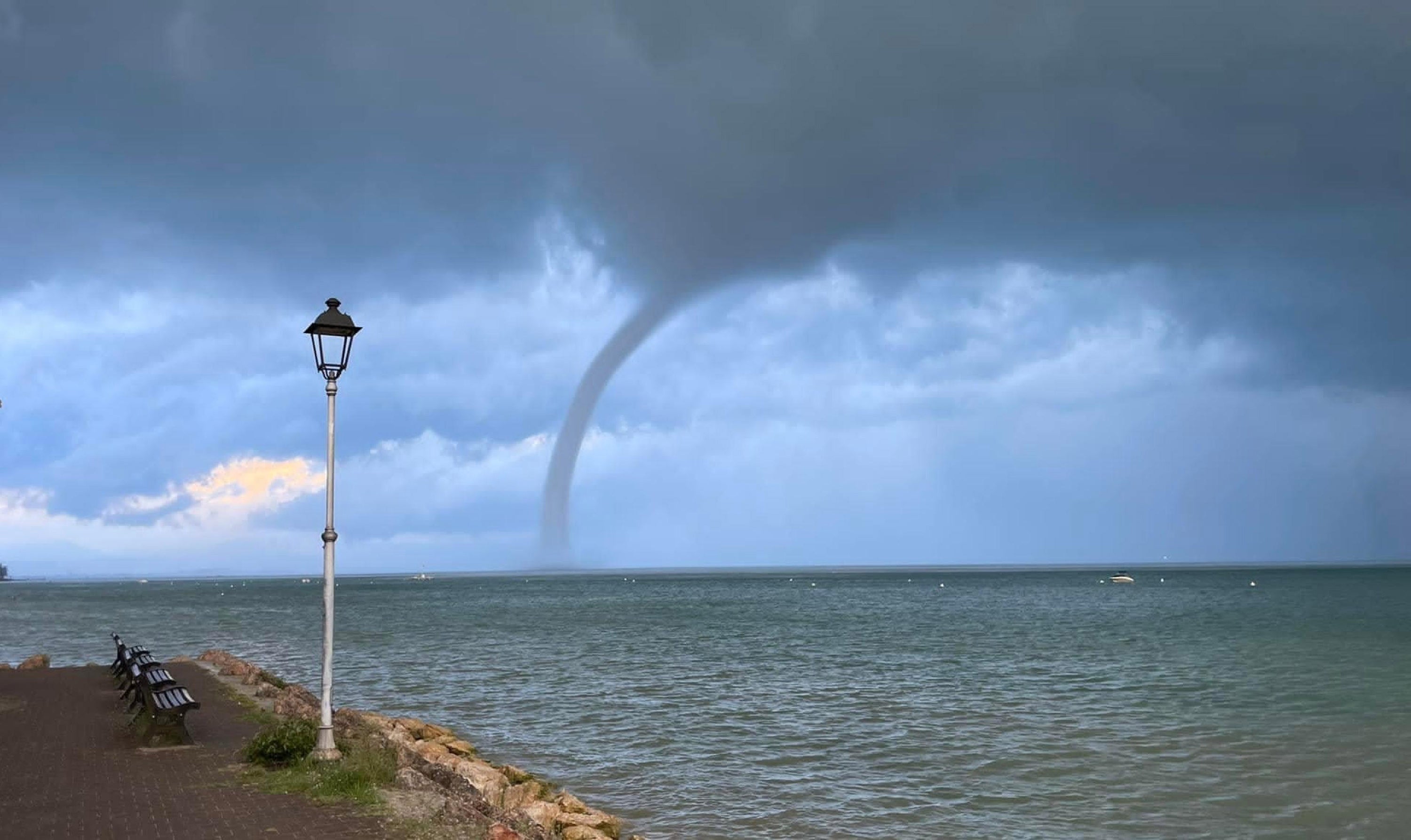 A tornado, or waterspout, is witnessed over the Veronese part of the Lake Garda, northern Italy,