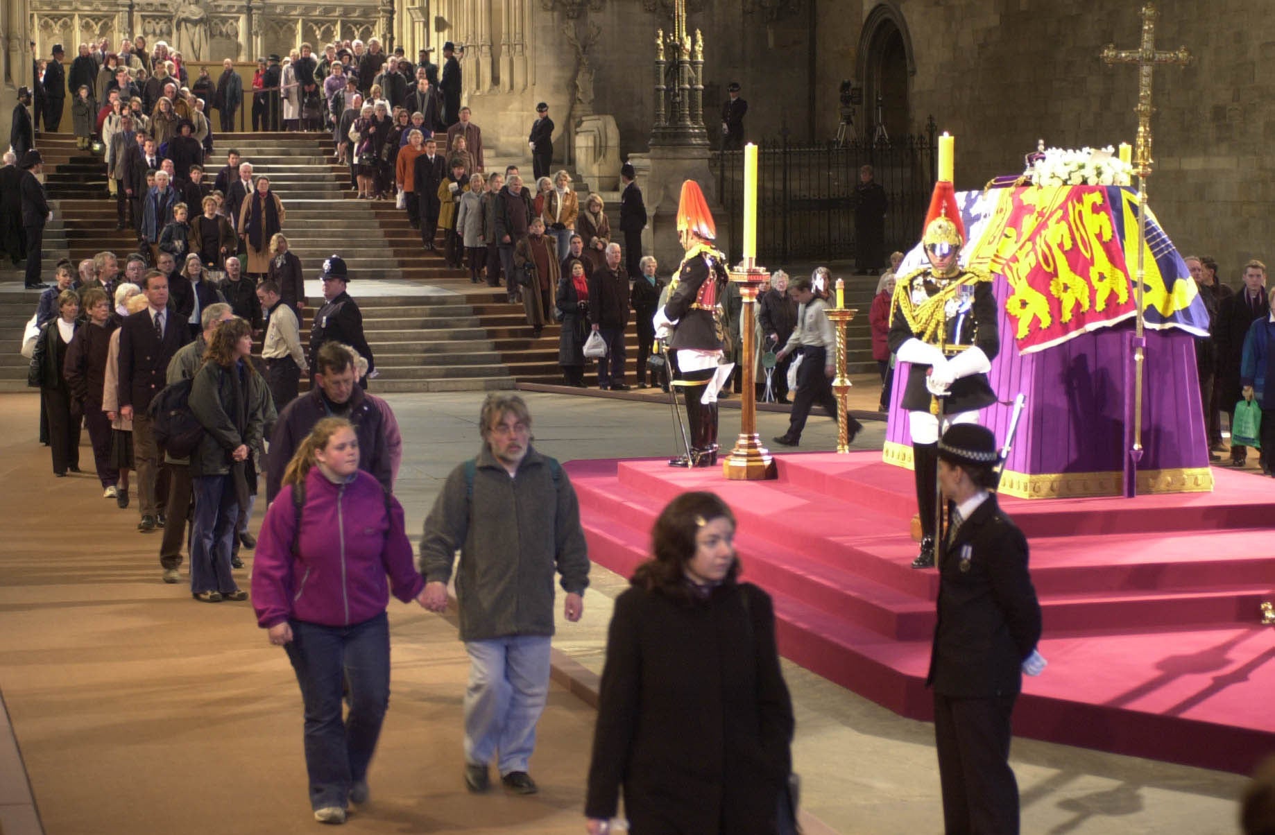 People walk past the coffin of the Queen Mother in Westminster Hall in 2002 (Stefan Rousseau/PA)